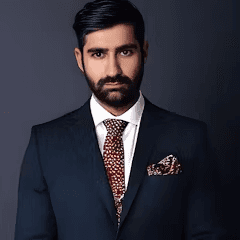 asian man wearing a suit with a black background
