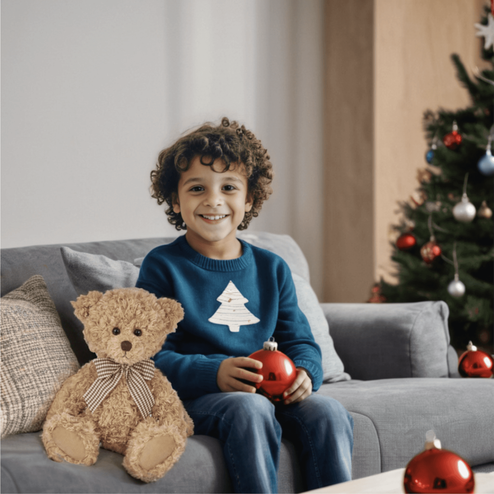 8 year old kid holding a teddy bear during christmas